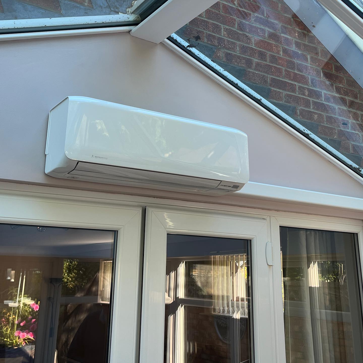 Professional aircon engineer installing system in Preston